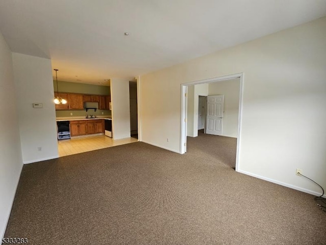 unfurnished living room featuring light carpet