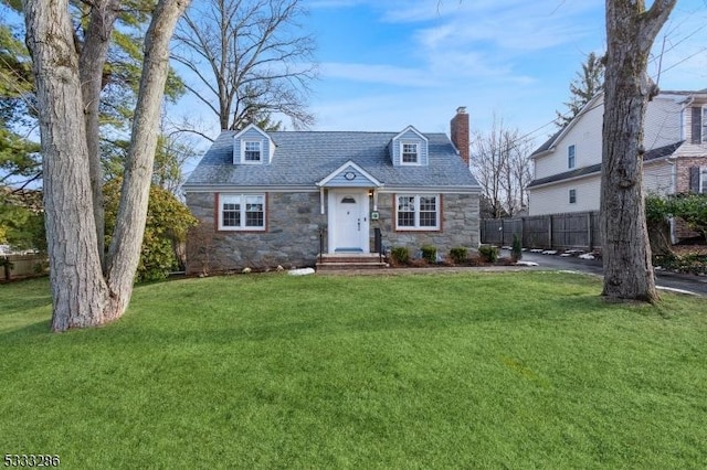 new england style home featuring a front yard