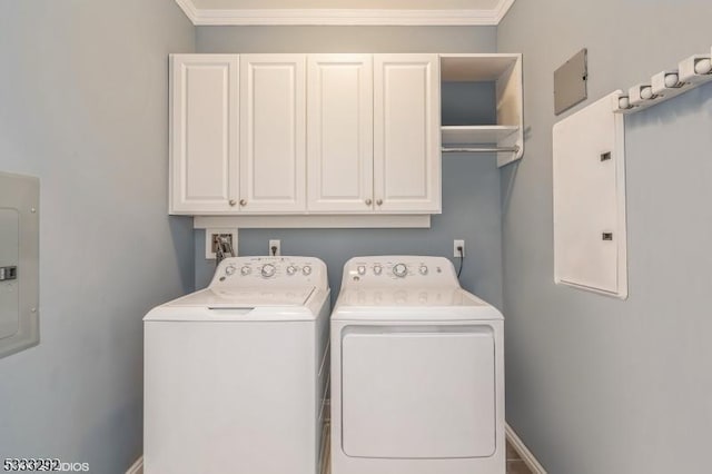 laundry area featuring electric panel, washer and clothes dryer, crown molding, and cabinets