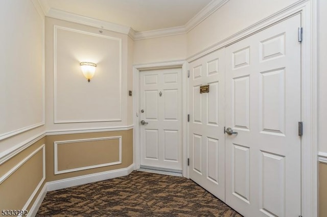 doorway to outside featuring ornamental molding and dark colored carpet