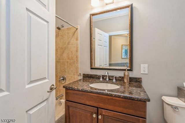 full bathroom featuring toilet, crown molding, tiled shower / bath combo, and vanity