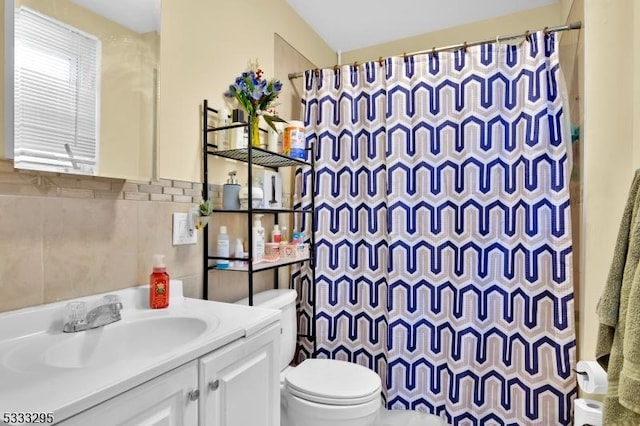 bathroom with toilet, vanity, tile walls, and walk in shower