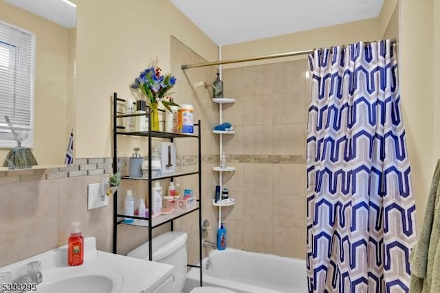 full bathroom featuring toilet, vanity, tile walls, and shower / bath combination with curtain