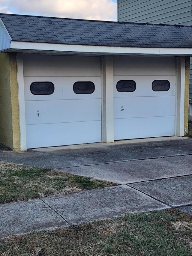 view of garage at dusk