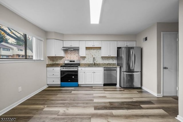 kitchen featuring stainless steel appliances, white cabinetry, and sink