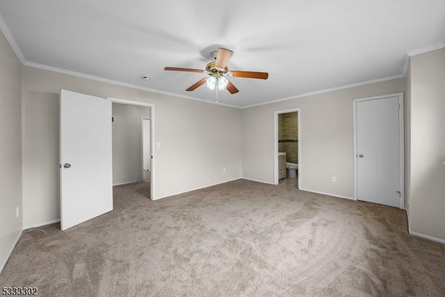 unfurnished bedroom with ceiling fan, ornamental molding, ensuite bathroom, and carpet