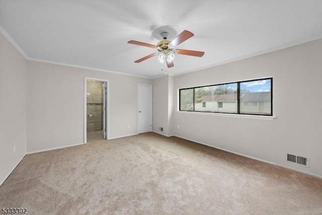 unfurnished bedroom with ceiling fan, ornamental molding, connected bathroom, and light colored carpet