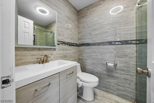 bathroom with toilet, a shower, tasteful backsplash, tile walls, and vanity