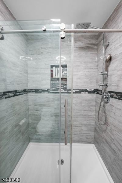 bathroom featuring a shower with shower door