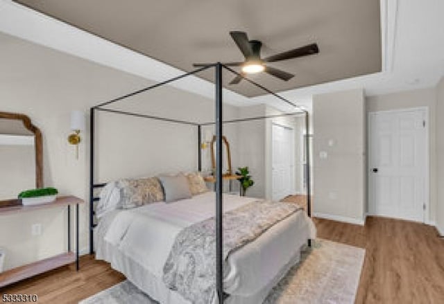 bedroom featuring ceiling fan and light hardwood / wood-style floors