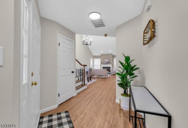 foyer featuring a notable chandelier and hardwood / wood-style flooring