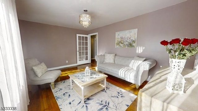 living room with a chandelier and hardwood / wood-style floors