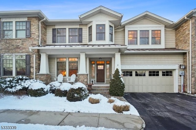 townhome / multi-family property featuring a garage and covered porch