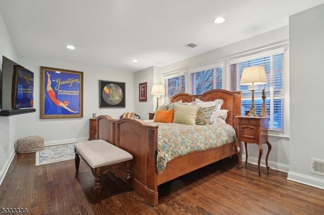 bedroom with dark hardwood / wood-style flooring