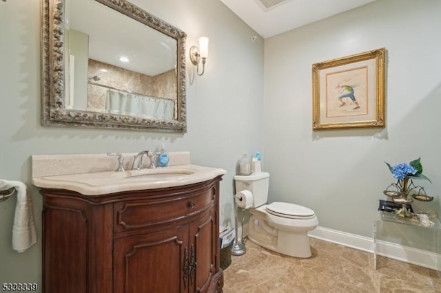 bathroom featuring vanity, curtained shower, and toilet