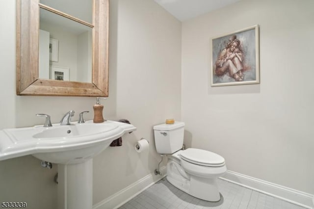 bathroom featuring tile patterned flooring and toilet