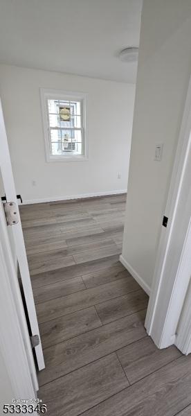 hall with wood-type flooring