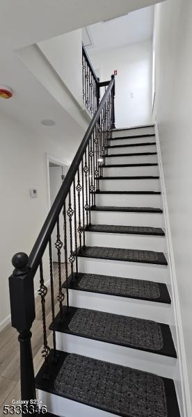 stairway featuring hardwood / wood-style floors