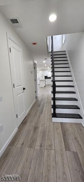 corridor with light hardwood / wood-style floors