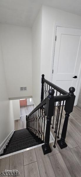 staircase with wood-type flooring