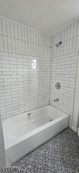 bathroom with tile patterned flooring and tiled shower / bath combo