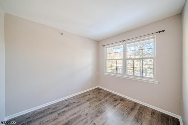 unfurnished room with hardwood / wood-style floors