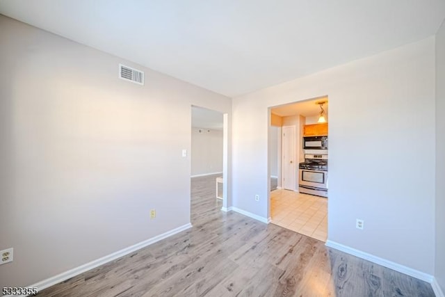 spare room featuring light hardwood / wood-style flooring