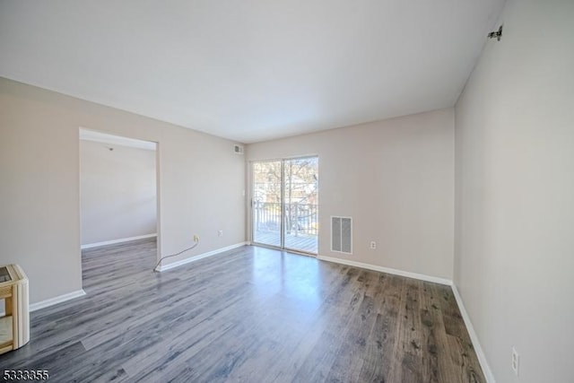 unfurnished room with dark hardwood / wood-style flooring