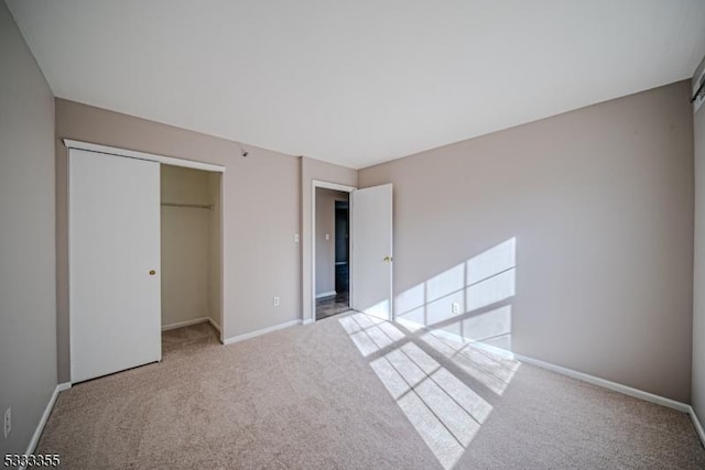 unfurnished bedroom with light carpet and a closet