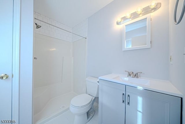 bathroom featuring a shower, toilet, and vanity