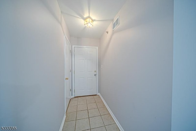 hall featuring light tile patterned floors