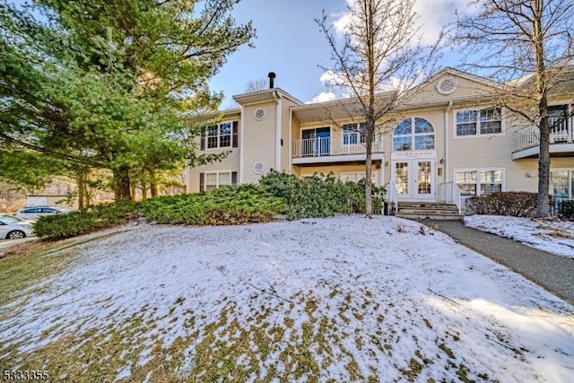 view of snow covered rear of property