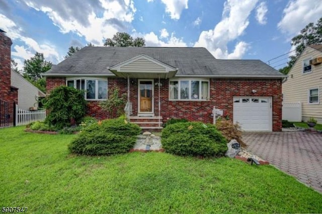 view of front of property featuring a front yard and a garage