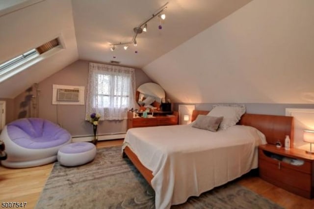 bedroom with lofted ceiling, an AC wall unit, a baseboard radiator, and hardwood / wood-style floors