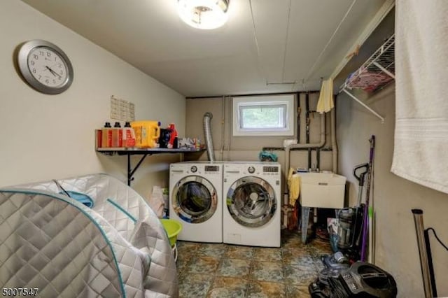 clothes washing area featuring washing machine and clothes dryer and sink