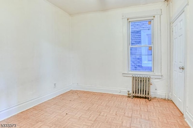 unfurnished room featuring light parquet floors and radiator