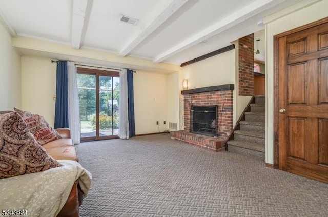 carpeted living room featuring beam ceiling and a fireplace