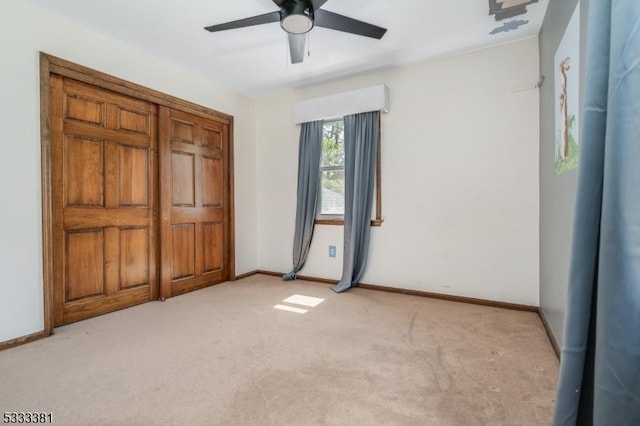 unfurnished bedroom featuring ceiling fan and light colored carpet