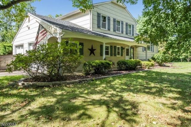 view of front of house with a front lawn and a garage