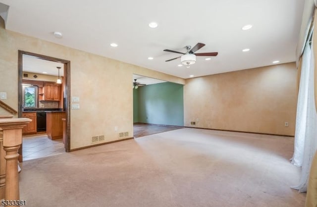 unfurnished room featuring ceiling fan and light colored carpet