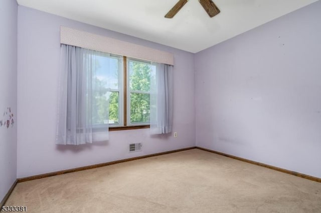 empty room with ceiling fan and light colored carpet