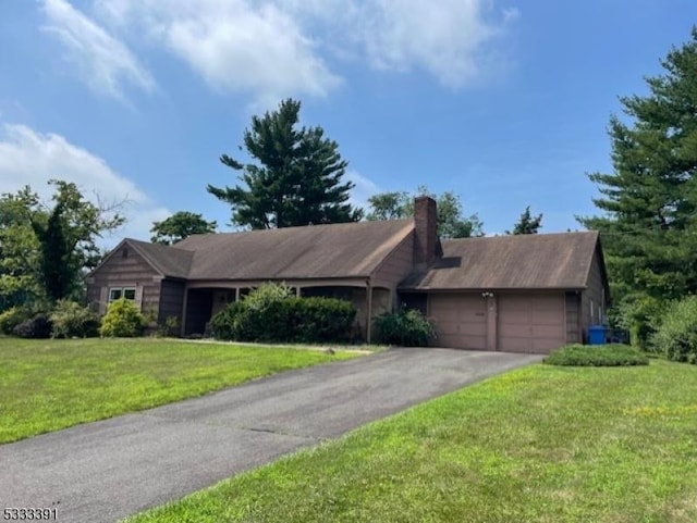 single story home featuring a garage and a front yard