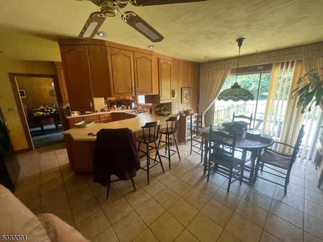 dining room with ceiling fan and light tile patterned floors