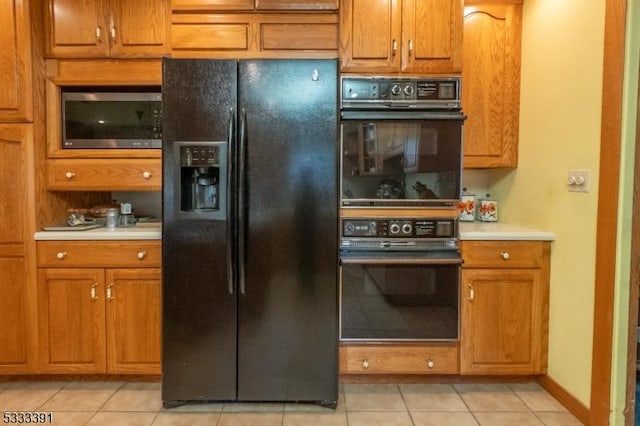 4 Webster Rd, Franklin Twp, NJ 08873 - kitchen with black appliances, light countertops, light tile patterned flooring, and brown cabinetry