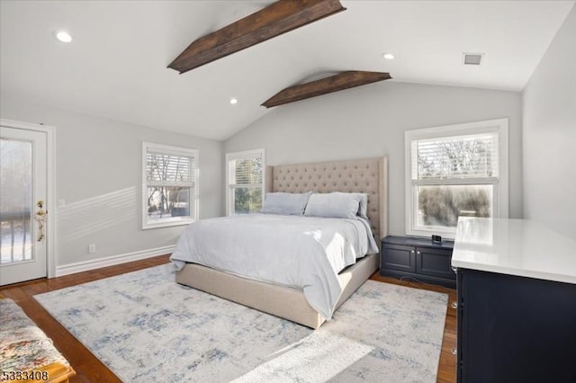 bedroom featuring hardwood / wood-style flooring, access to exterior, and vaulted ceiling with beams