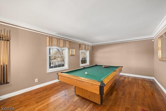 recreation room featuring billiards, ornamental molding, and dark hardwood / wood-style flooring