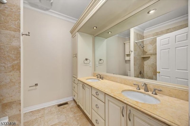 bathroom with crown molding, vanity, and toilet