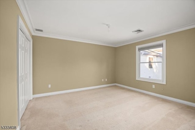 unfurnished room featuring light colored carpet and ornamental molding