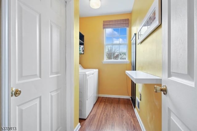 30 Stirrup Ln, Raritan Twp, NJ 08822 - washroom with baseboards, wood finished floors, laundry area, and washing machine and dryer