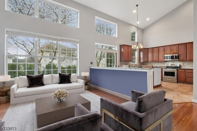 30 Stirrup Ln, Raritan Twp, NJ 08822 - living room featuring recessed lighting, an inviting chandelier, light wood-style floors, and a towering ceiling
